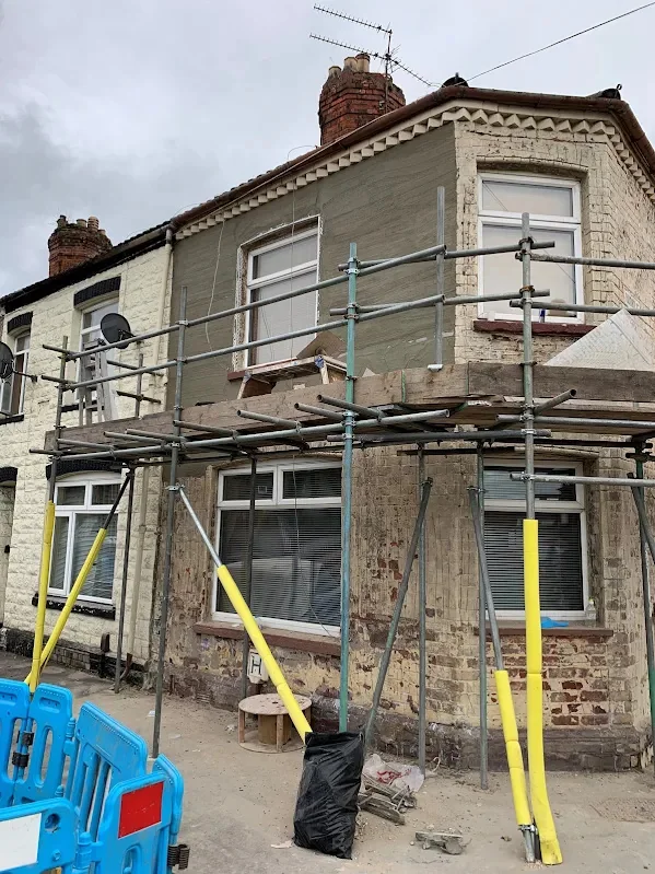 Corner house before the job, the old finish off and the brickwork open under scaffold