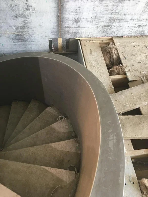 Spiral concrete staircase with the curved wall rendered round it