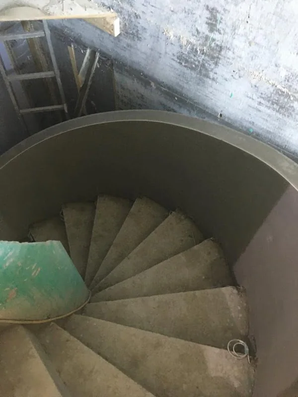 Curved wall around a spiral staircase, floated up and ready for finishing