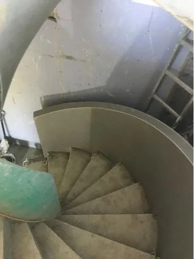 The finished curved wall wrapping the spiral staircase