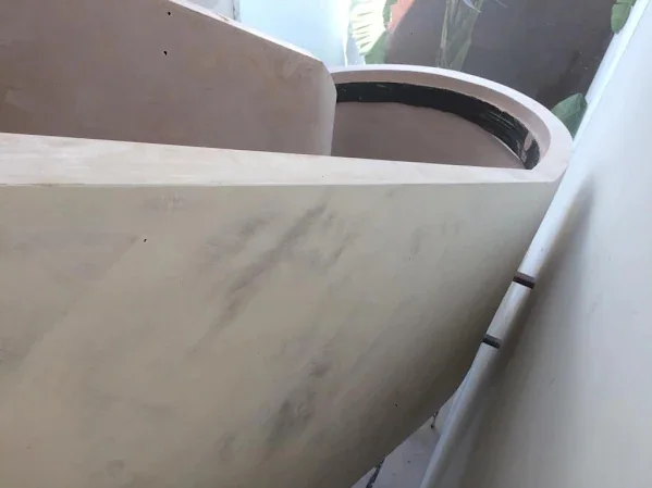 Close-up of the curved edge of a stair void, skimmed to a clean arris