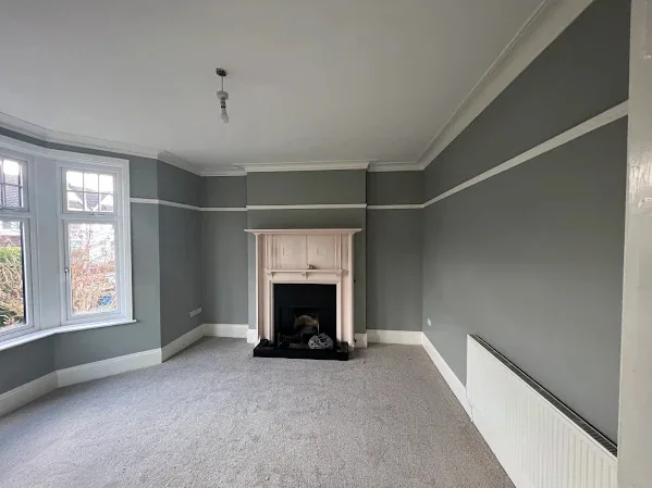 Bay-fronted room decorated after plastering, picture rail and cornice picked out
