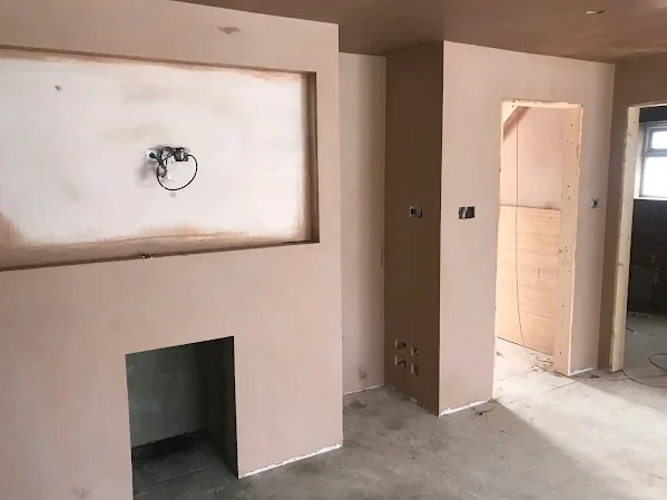 Media wall built off a chimney breast, boarded and taped ready to skim