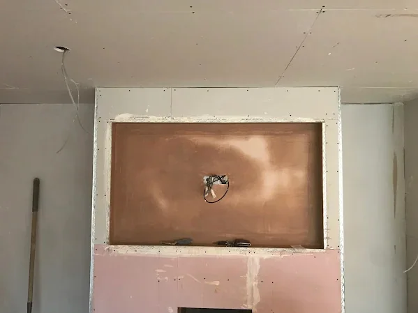 Screen recess boarded out inside the media wall frame