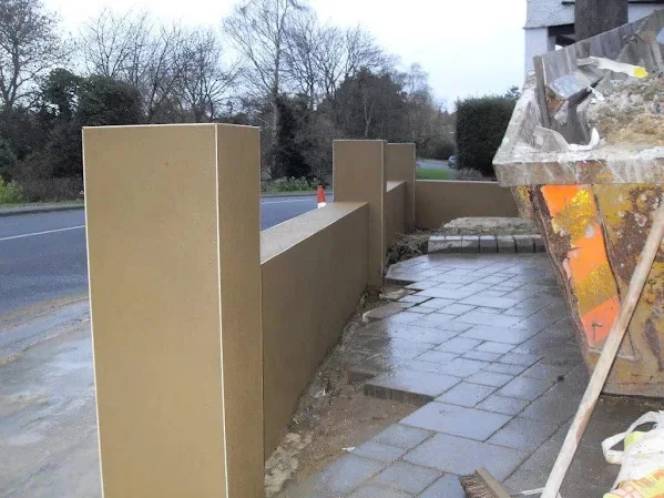Rendered boundary wall turning the corner into the drive
