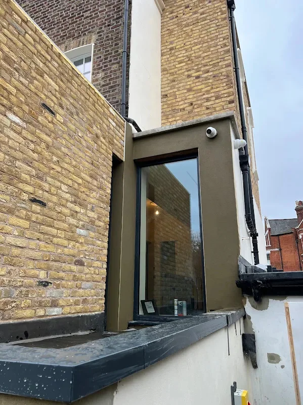 Render meeting the original yellow brick on a modern extension