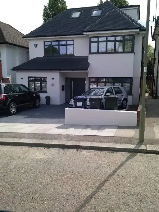 Detached house rendered white, with the front garden wall rendered to match