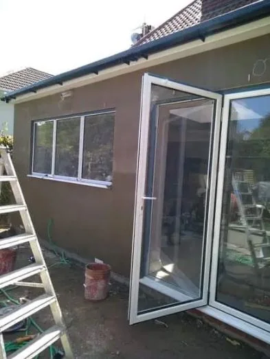 Single-storey rear extension rendered out around a bi-fold door opening