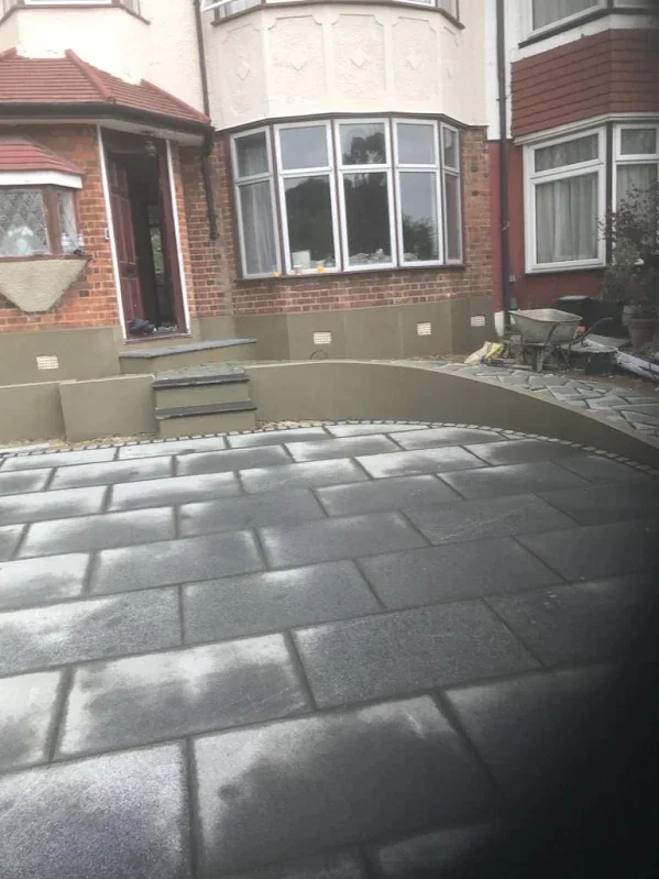 The same front garden wall from the drive, the curve carried its full length