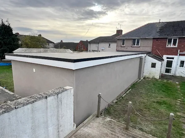 Flat-roofed garage in a back garden rendered out to a clean edge