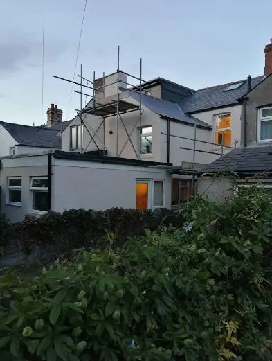 Rear elevations of a terrace rendered white, seen from the garden