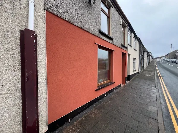 Rendered terrace front from up the street, the colour carried across the full elevation