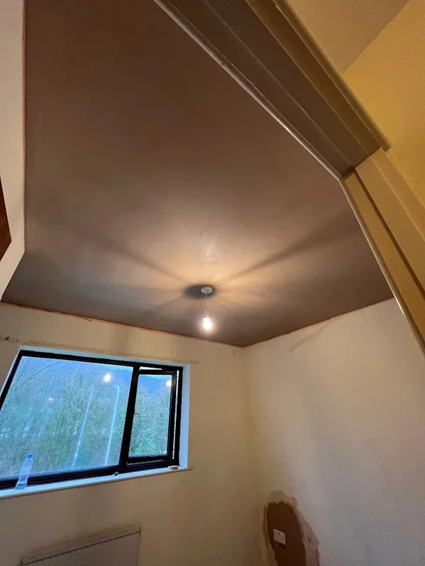 Ceiling and walls skimmed around a new window, the reveals kept square