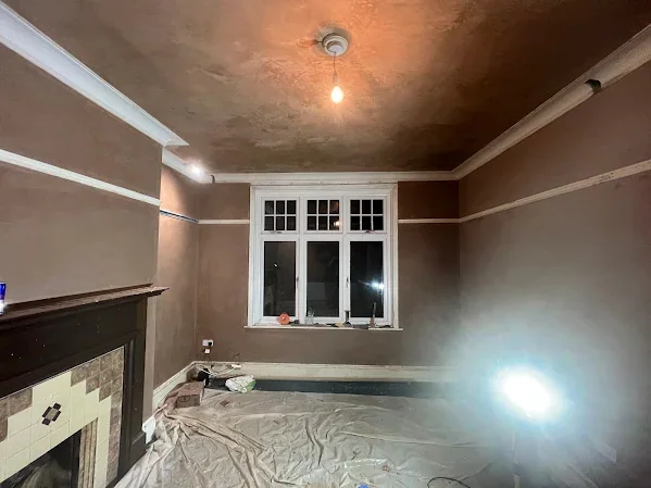 Front room skimmed above and below the picture rail with the fire surround left in place