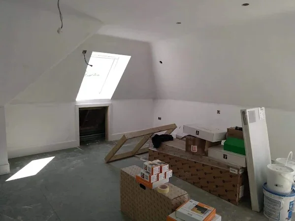 Loft conversion boarded, skimmed and painted around the rooflight and the coombed ceiling