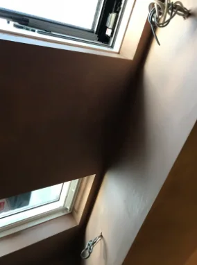 Loft room sloped ceiling skimmed around a roof window