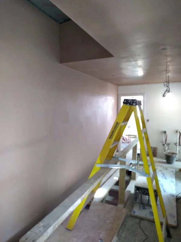 Room skimmed round a bulkhead, the angles beaded and run straight