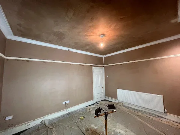 Large room skimmed up to the existing coving, the radiator left on the wall