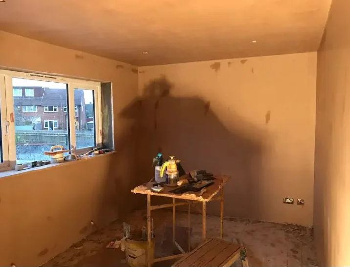 Reception room skimmed out in one hit, walls and ceiling, with the window reveal squared up